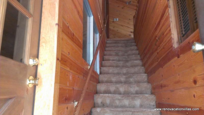 The left hand door at bottom of the stairs opens to the laundry room